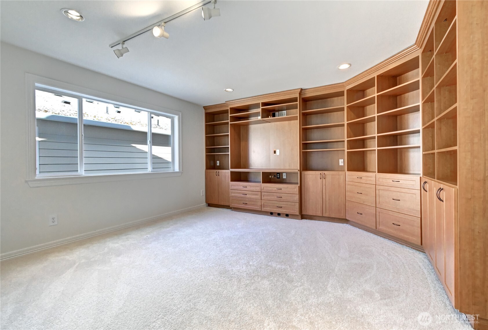 Upstairs bonus room features a wall of built-ins.