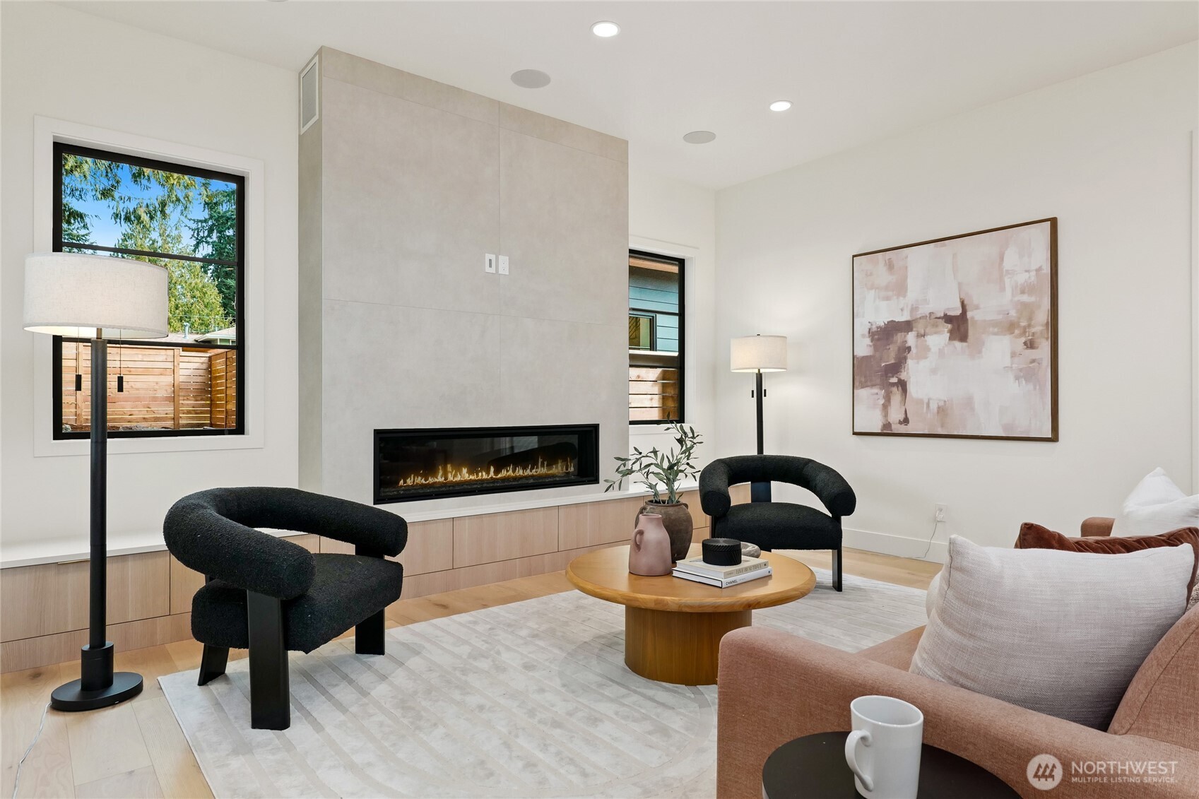 Cozy Living Room with In-Ceiling Speakers and Urbana Fireplace with Custom Built-Ins and floor to Ceiling Surround