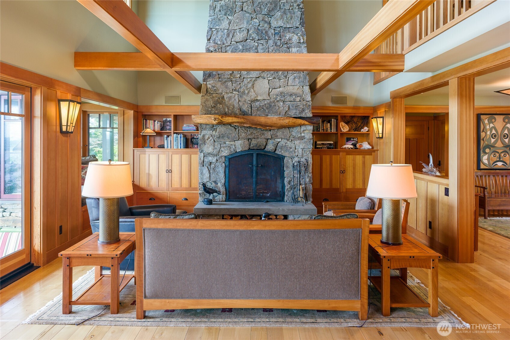 The stone fireplace with madrona mantel and built-in media and TV cabinets on each side.
