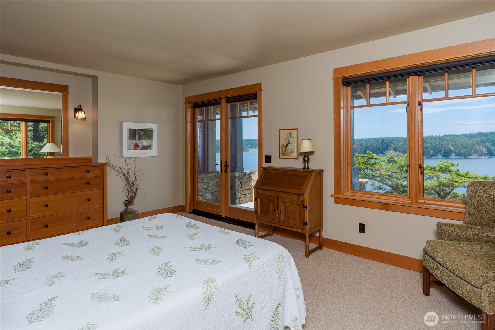 Main floor primary bedroom has built-in dresser and French doors to the patio.