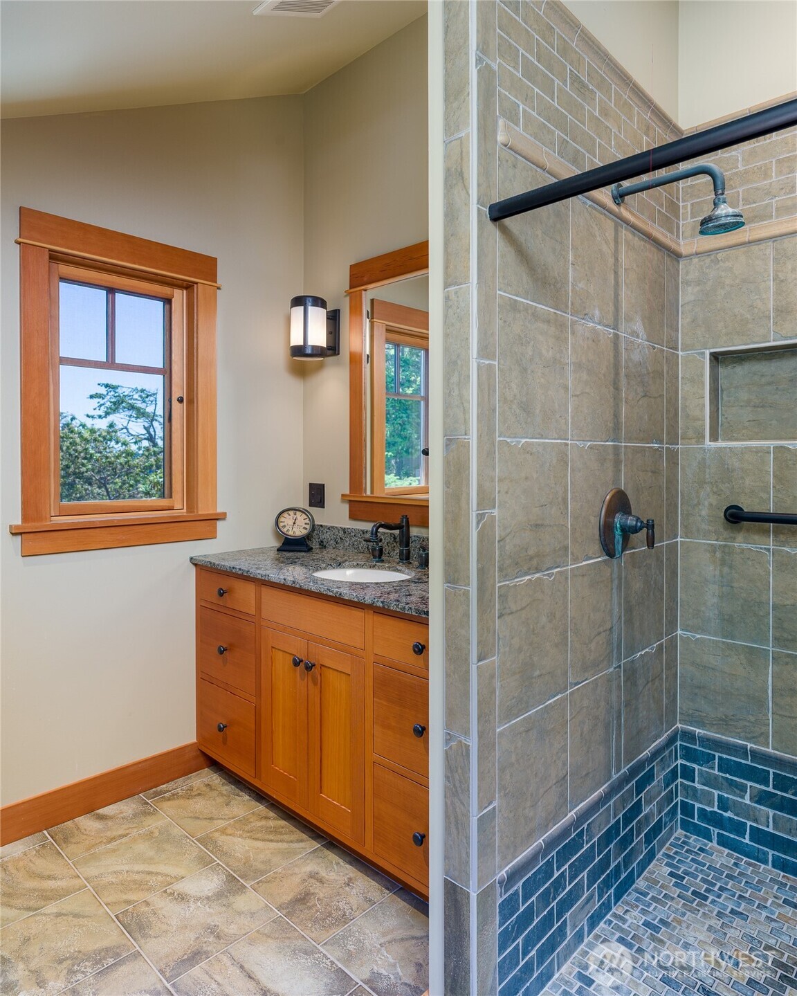 Bathroom for third bedroom has single sink and tile shower.