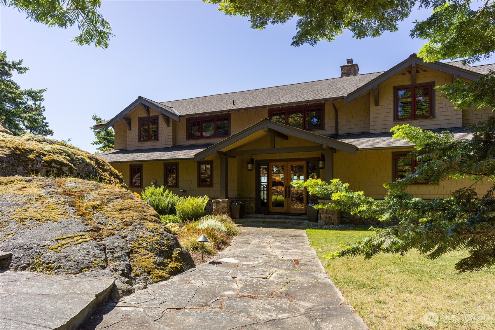 Beautiful clear fir doors grace the entrance of this 3 bedroom and bath side shingled home.