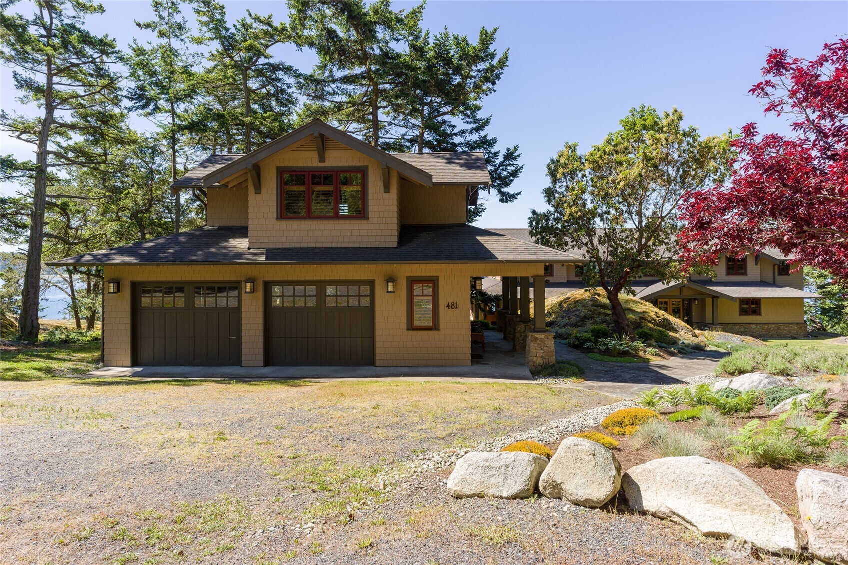The detached 2 car garage with studio above greets you.
