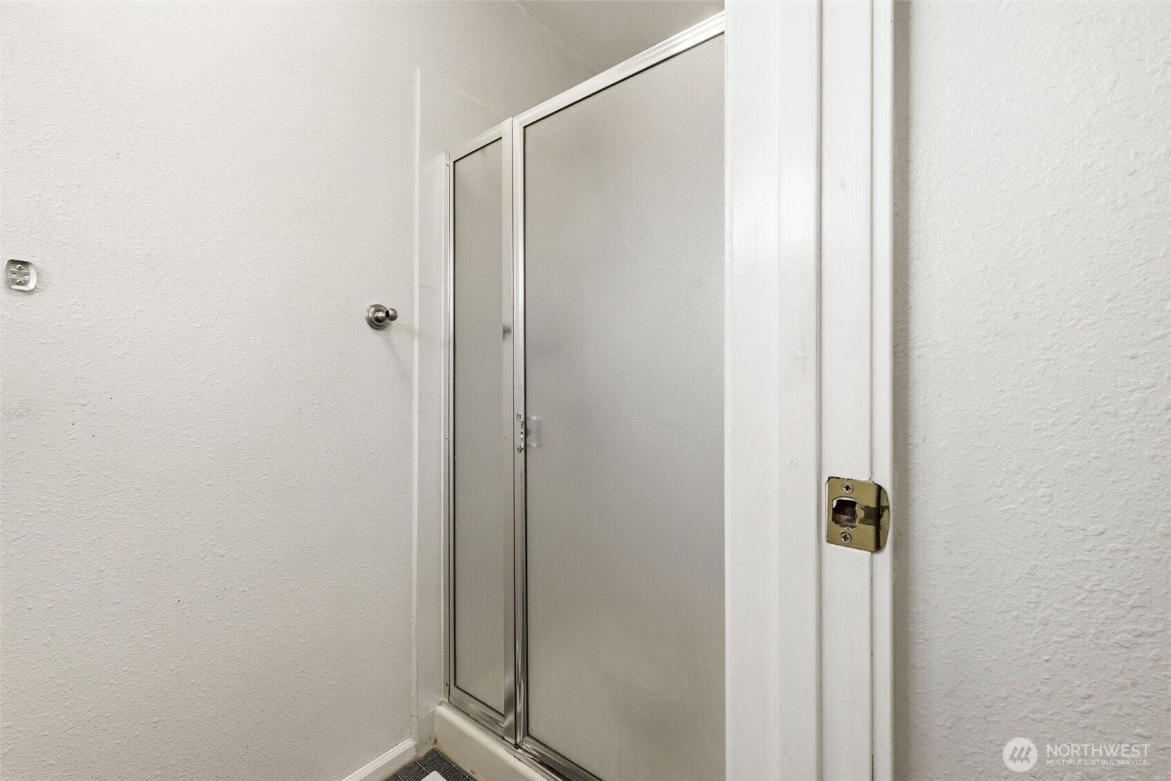 Primary bathroom featuring a walk-in shower.