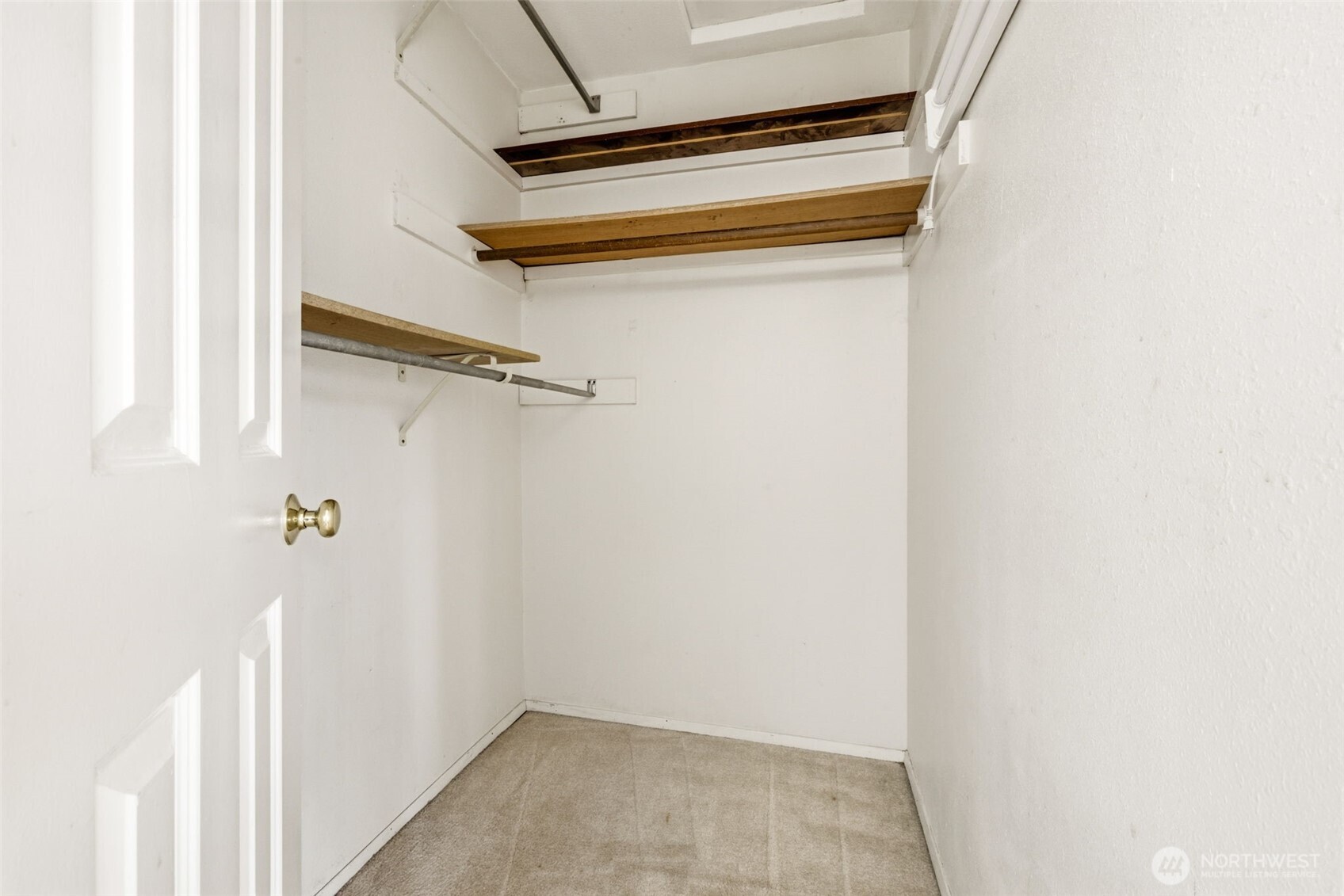 Primary walk-in closet offering generous hanging space and organization potential.