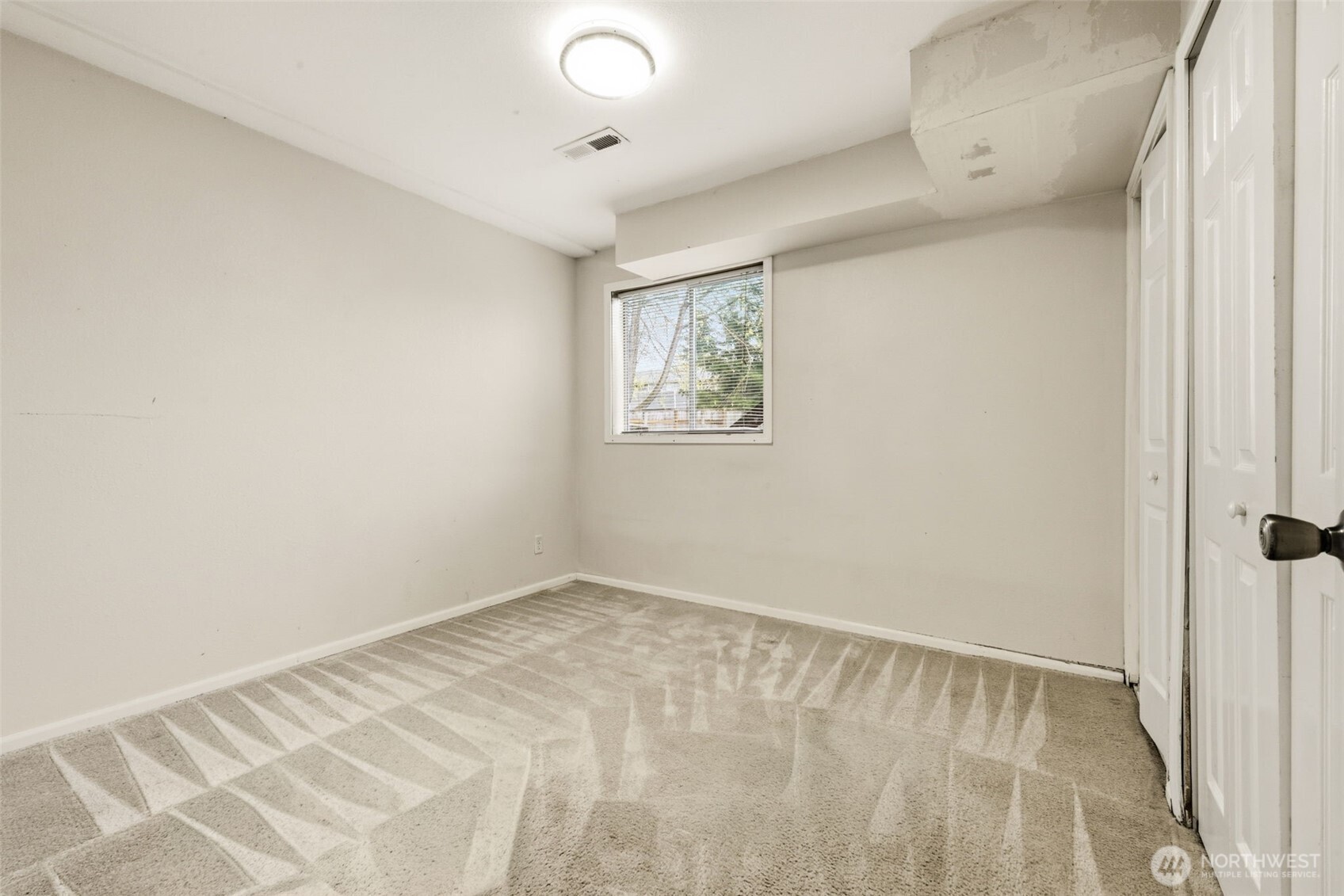 Bedroom 4 on the lower level—ideal for flexible use, workspace, or additional living needs.