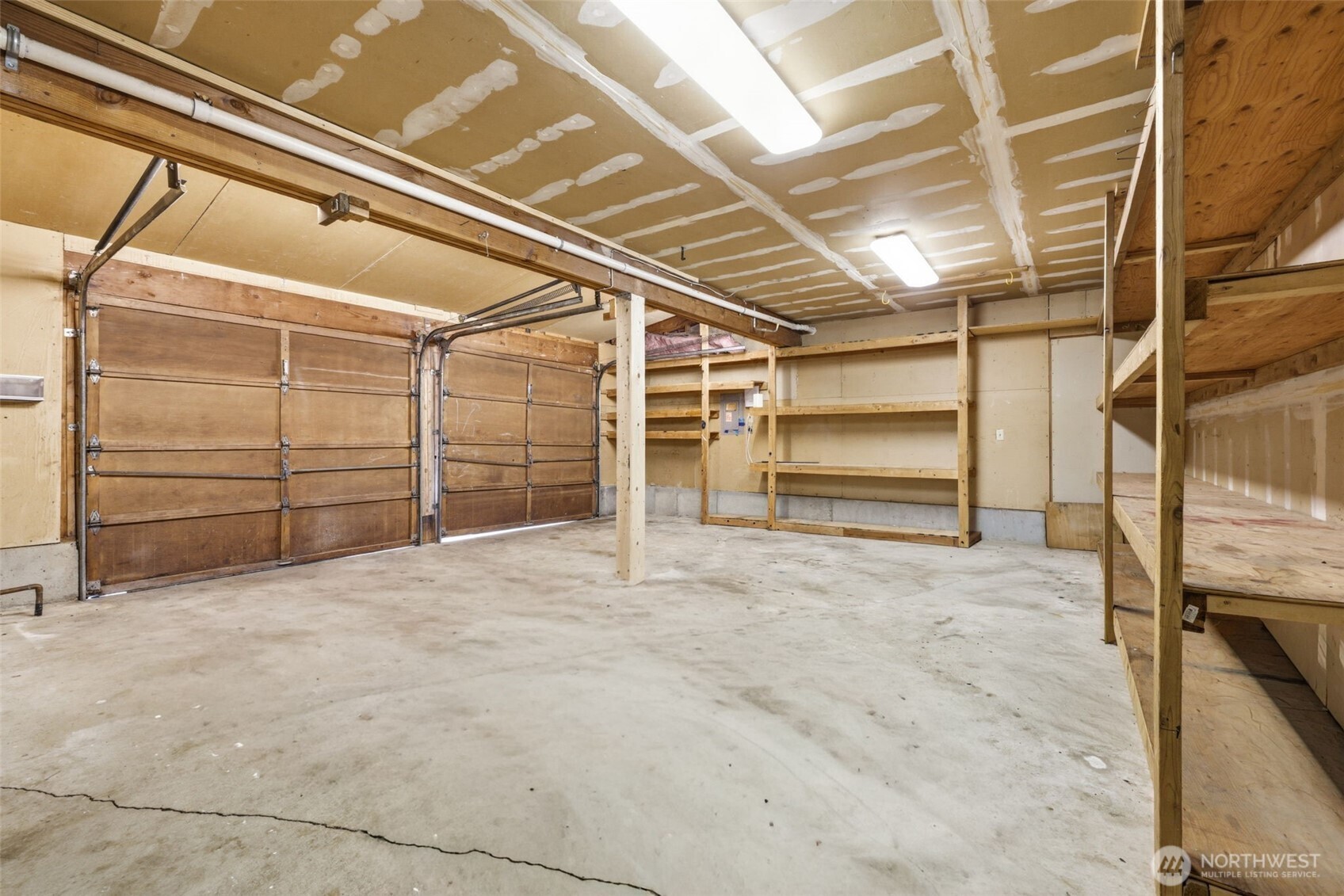 Spacious 2-car garage (approx. 490 sq ft) featuring ample shelving and storage.