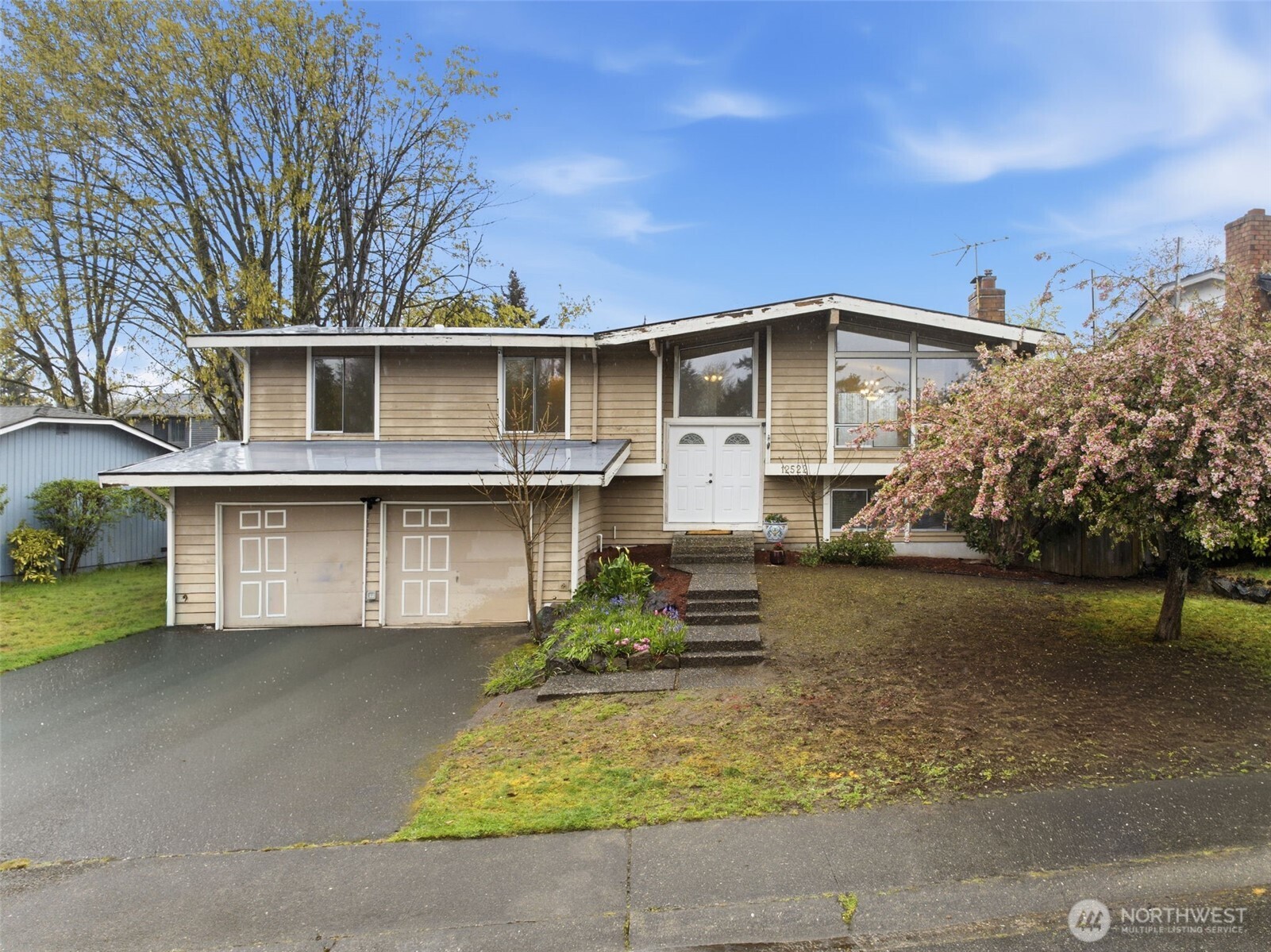 Situated on a generous lot, this home features a large driveway, mature trees, and room to personalize and make it your own.
