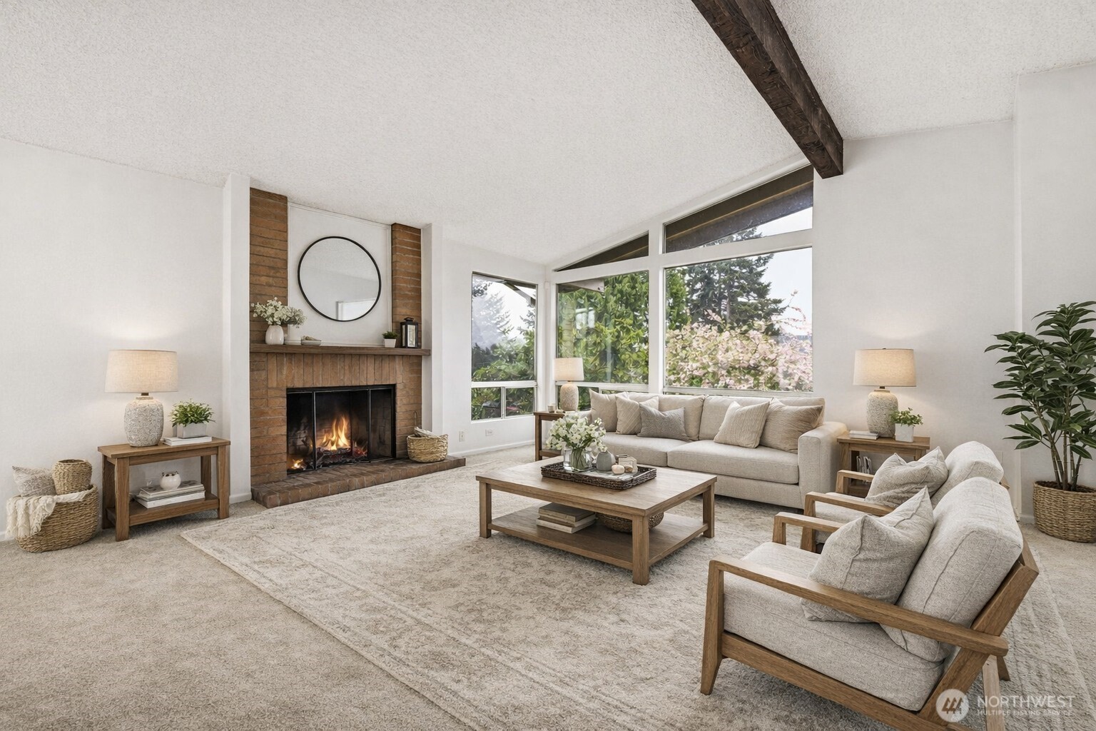 Enjoy easy living and entertaining in this open-concept layout connecting the living and dining areas with warmth and natural light. (Carpet is photo enhanced.)