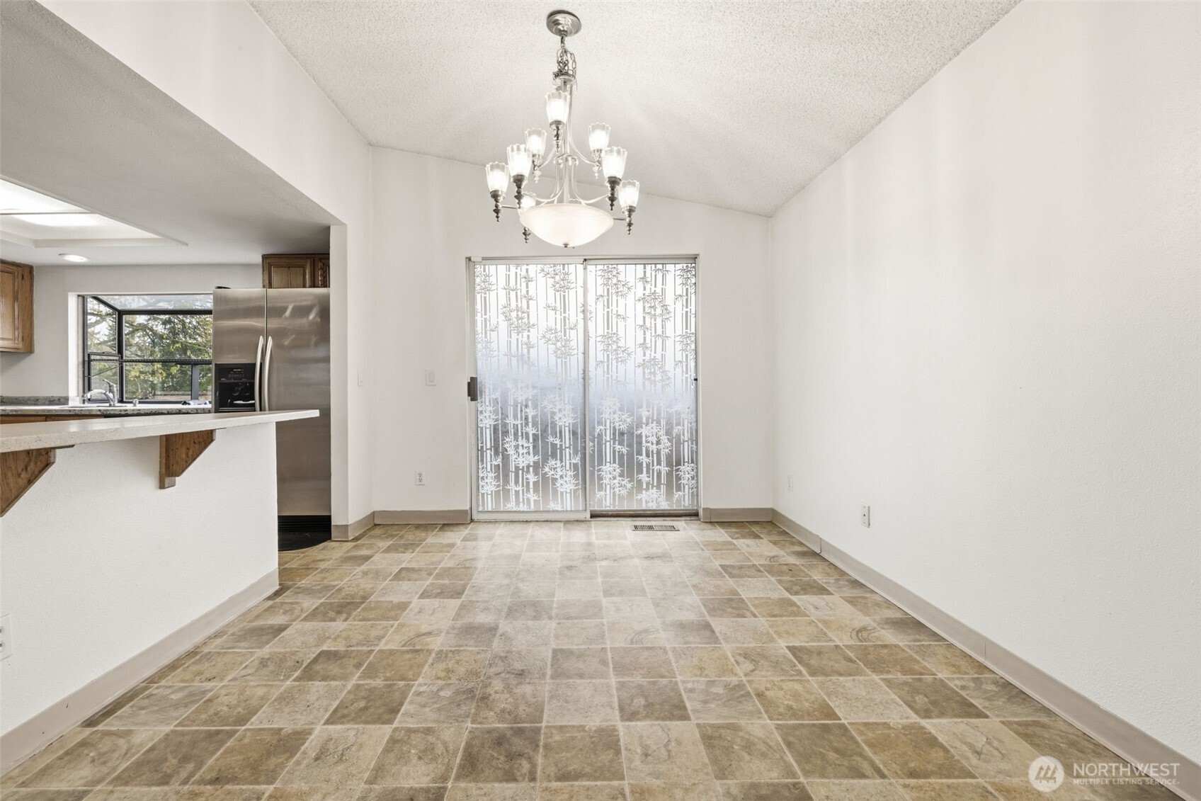 Enjoy meals in this light-filled dining area with direct access to the patio—perfect for indoor-outdoor living.