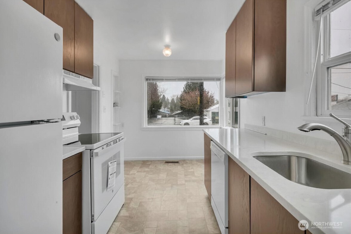 Eat-in kitchen with natural light. New appliances and cabinets.