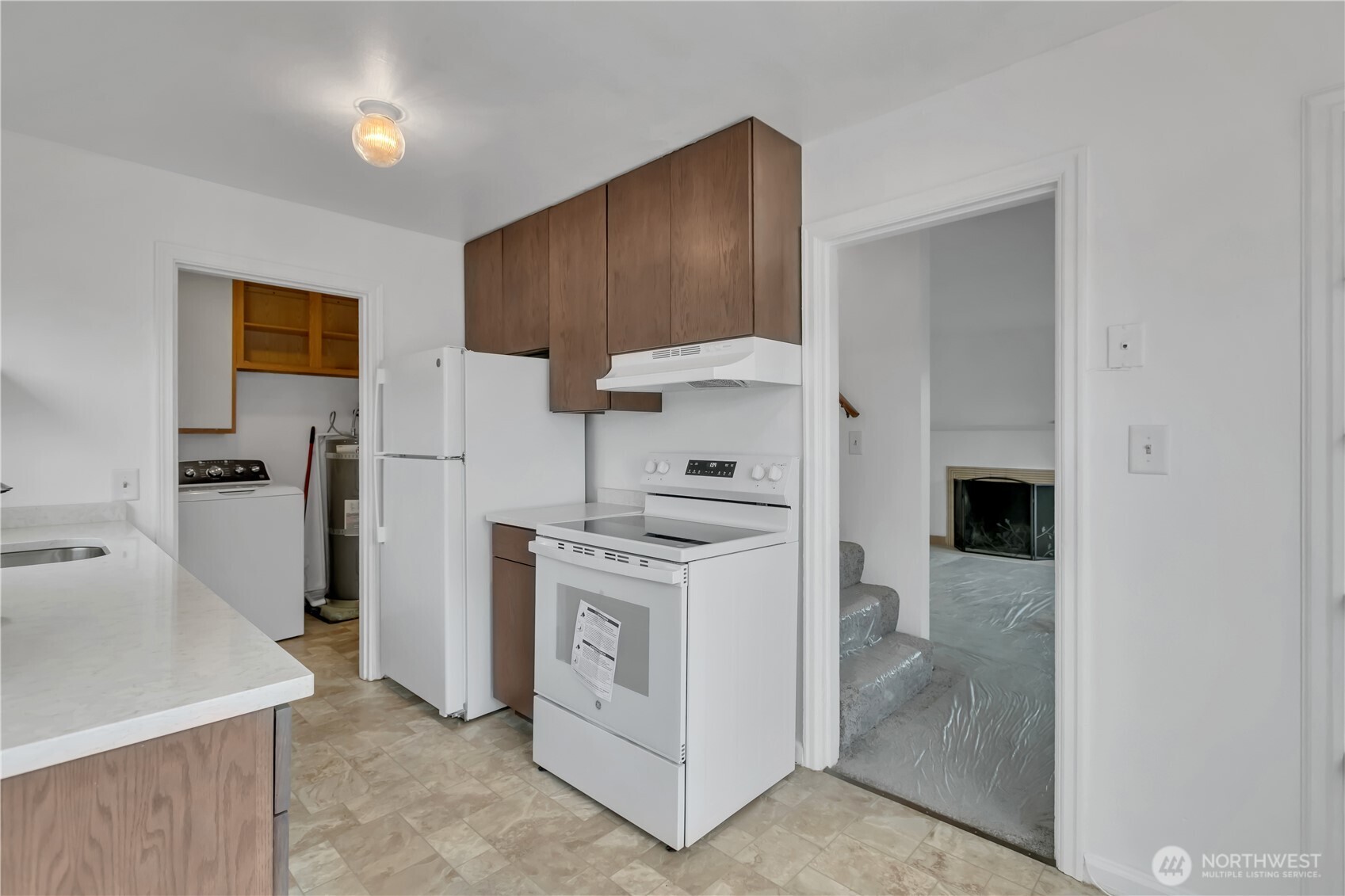 Kitchen with access to living room and stairs to the upstairs bedrooms.