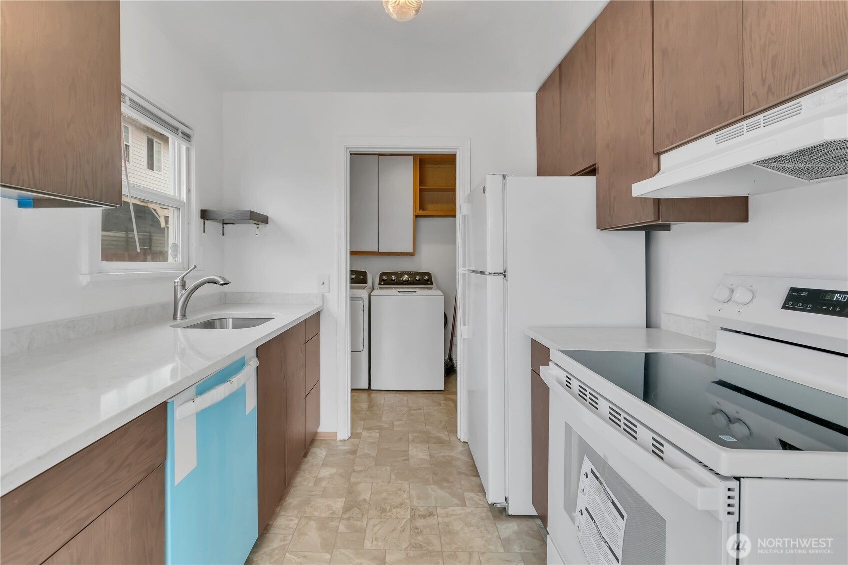 Kitchen with protective cover on the new dishwasher.