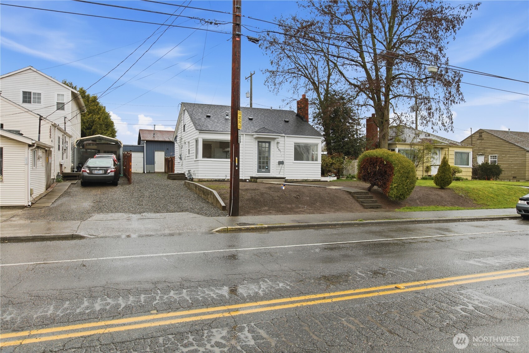 View of home from the street. Stairls and sidewalk to the front door.
