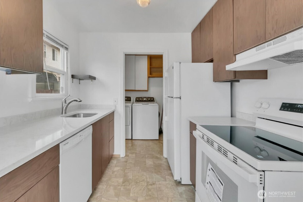 Kitchen view towards laundry. (virtually removed blue plastic from dishwasher)