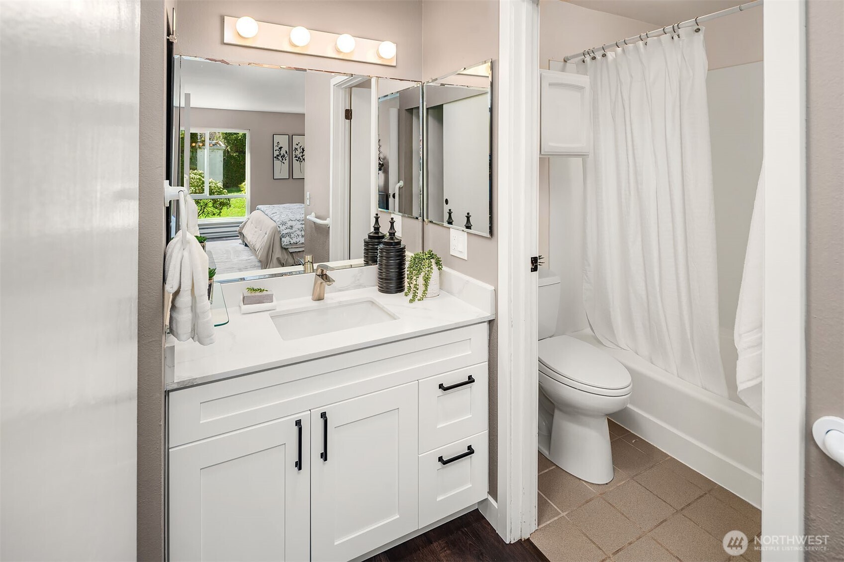 Primary full bathroom with new vanity and quartz countertops.