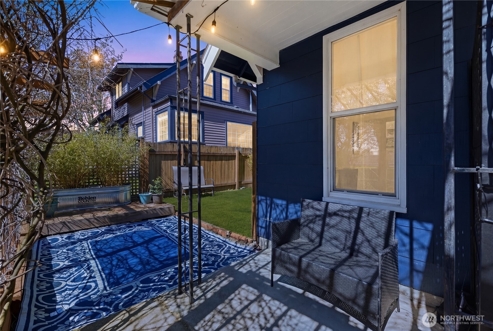 Enjoy the spring sunset or sunshine on your front patio, filtered through the hundred year old wisteria