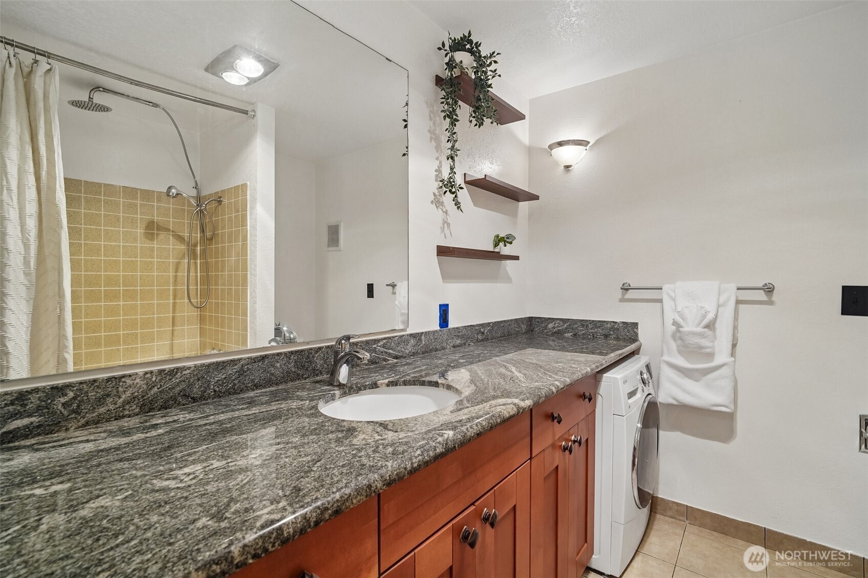 Large Bathroom with Combo-Washer & Dryer that saves space and energy.