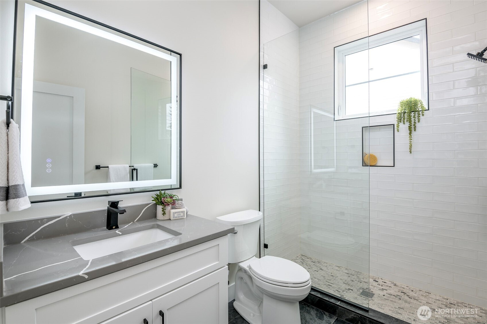 Striking designer chandelier creating a bright and architectural focal point over the entry.