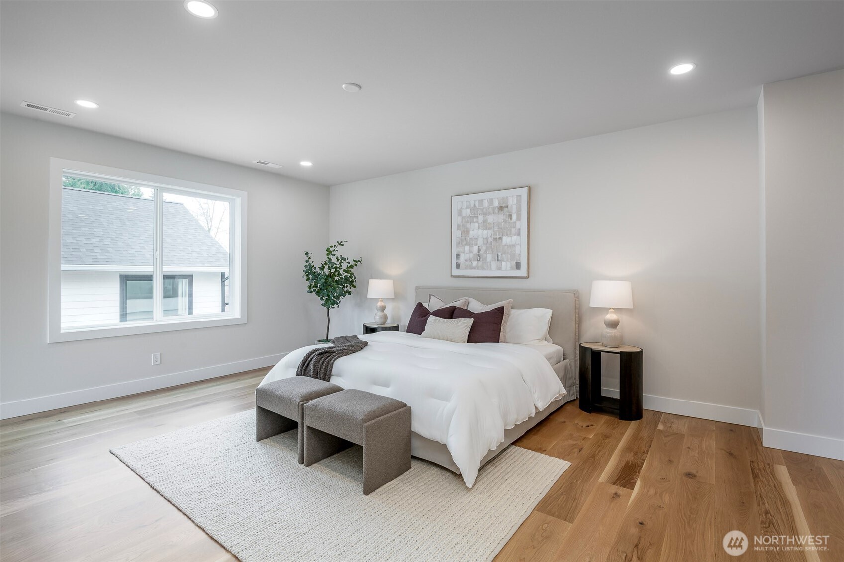 Spa-inspired primary bath featuring a luxurious walk-in shower with designer tile, freestanding soaking tub, heated floors, dual vanity with high-end finishes.