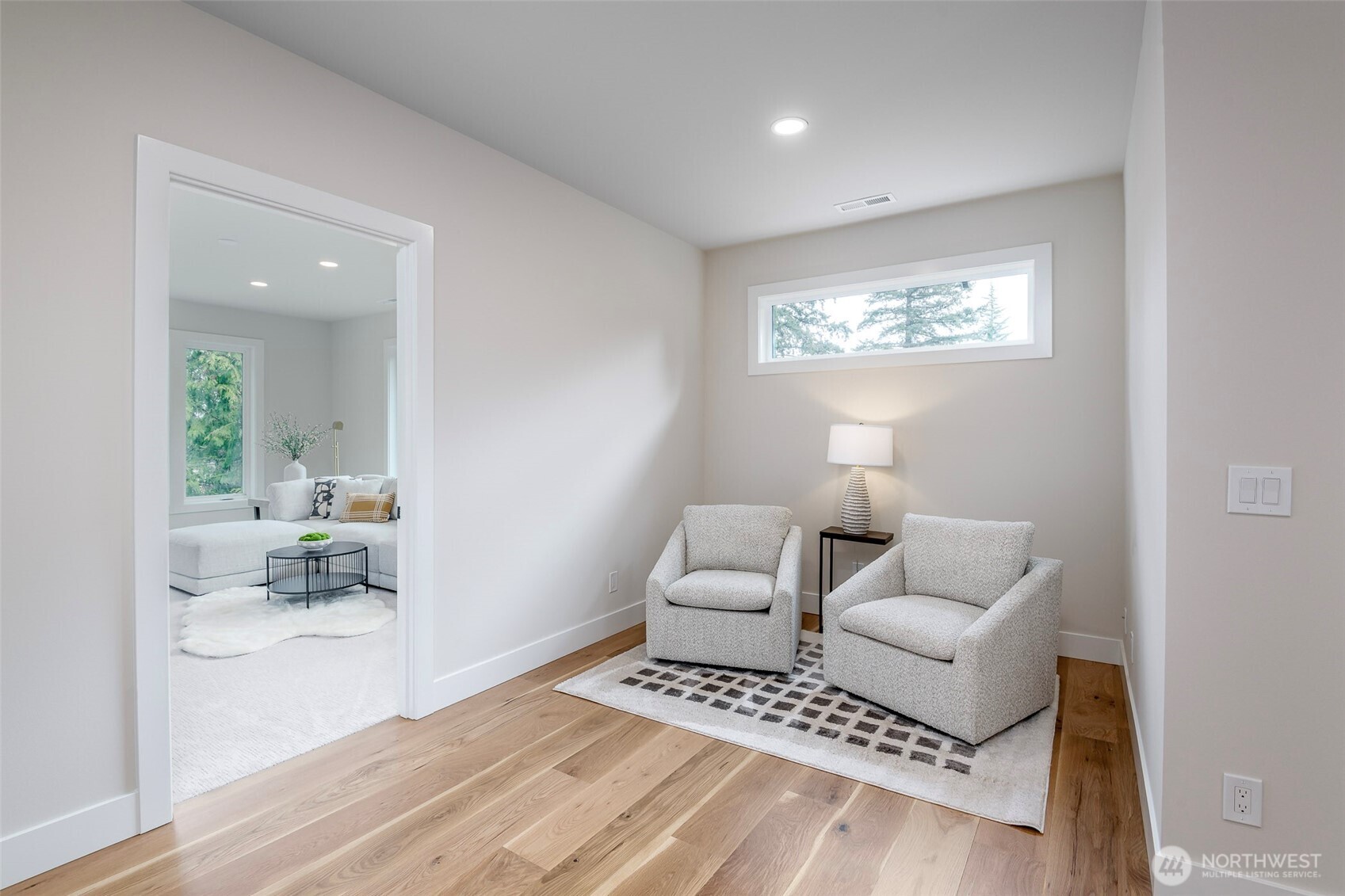 Spacious bonus room with expansive windows and abundant natural light, offering endless possibilities for a media room, playroom, home gym or additional lounge space.