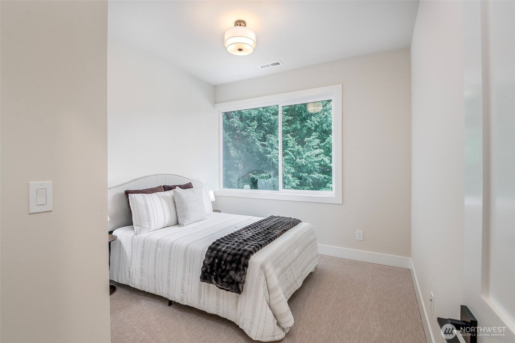 Covered outdoor living space with sleek modern design and seamless access to the backyard, perfect for year-round entertaining and relaxation.