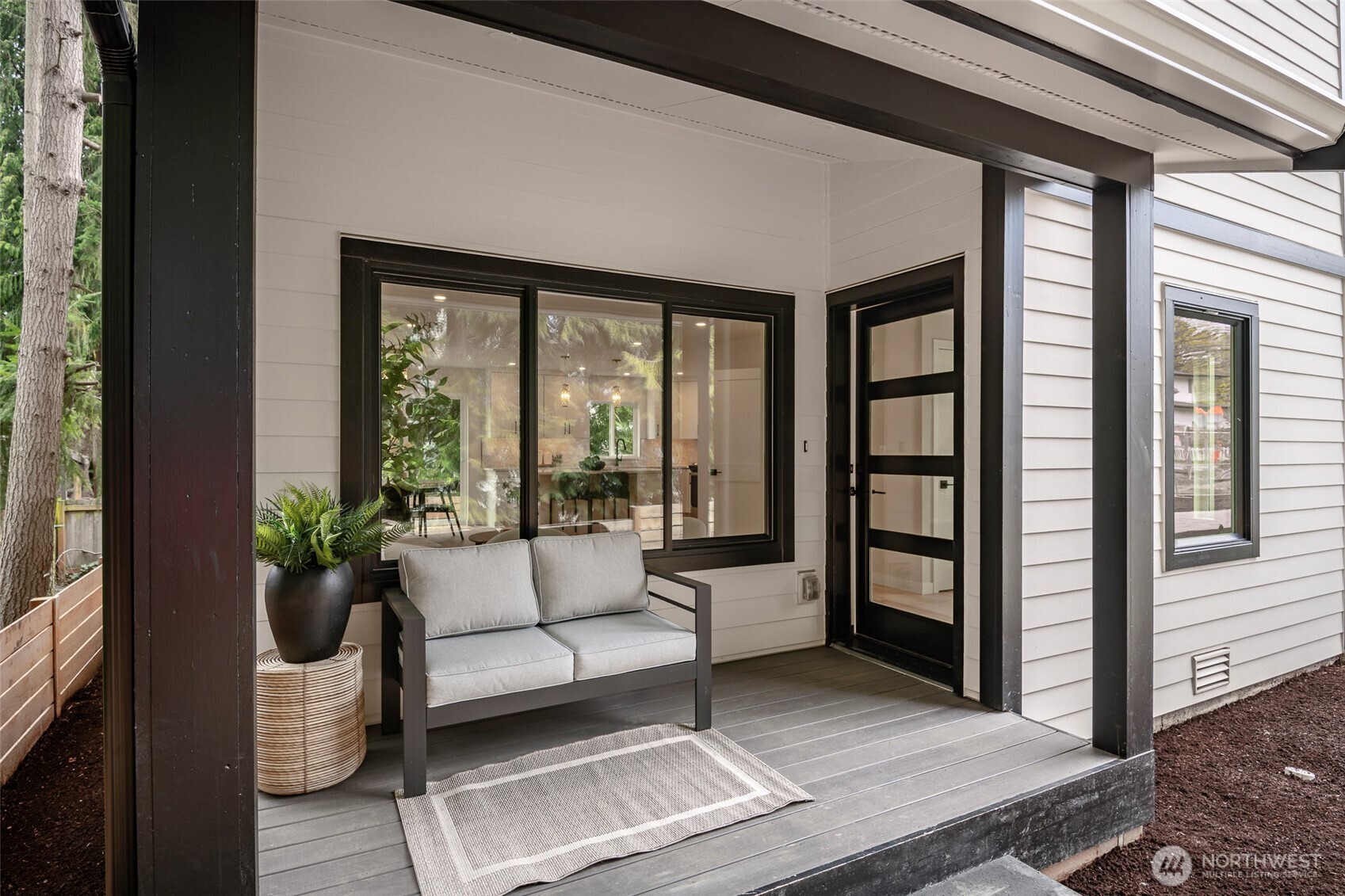 Bright open-concept living space in the DADU featuring a full kitchen, dining area, and comfortable living room designed for easy everyday living.