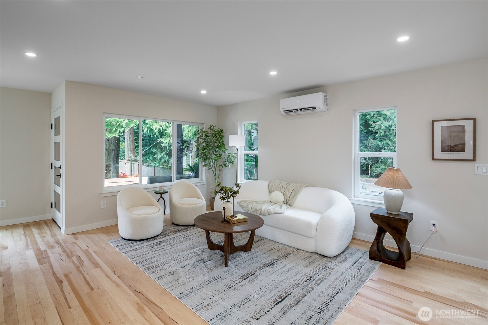 Dining area with expansive windows and sliding glass doors, statement lighting to pull it all together.