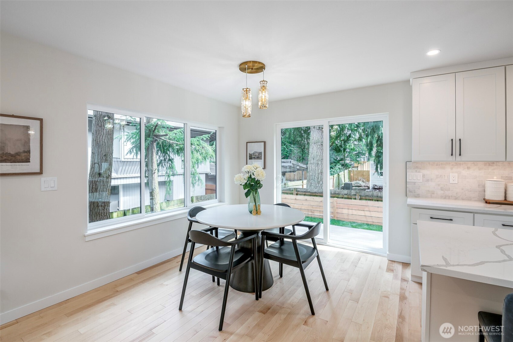 Stainless steel appliances, white shaker cabinets, walk-in pantry space and a beautiful tile backsplash.