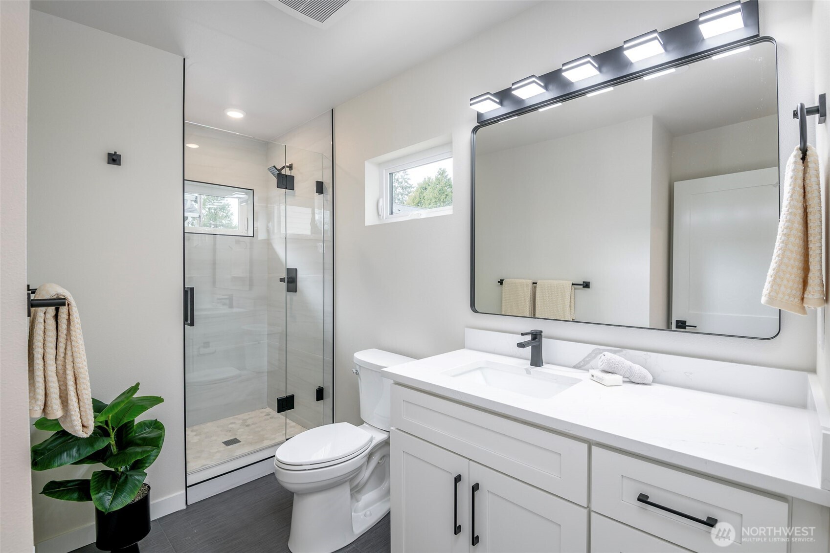 Private backyard Oasis connecting the main home and DADU, featuring lush lawn and inviting outdoor spaces ideal for relaxation and entertaining. A rare opportunity to enjoy multi-generational living or potential income!