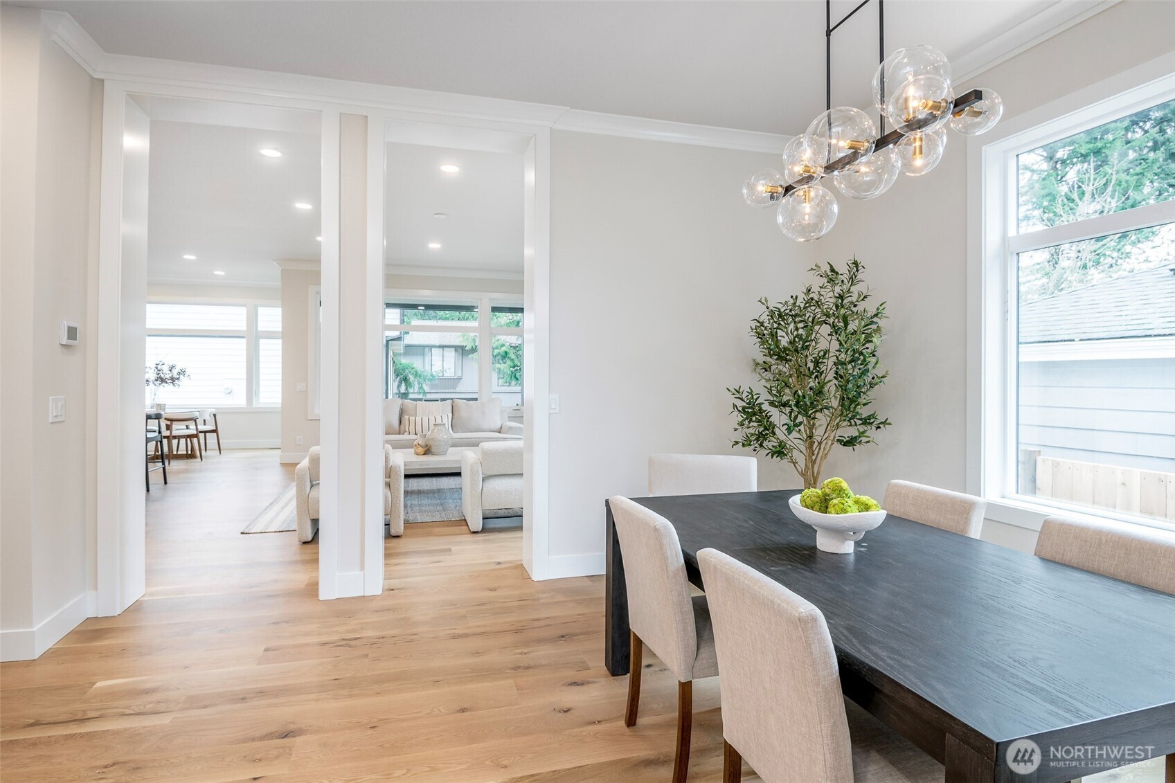 Bright, open living room with recessed lighting, sleek modern fireplace creating a stylish gathering space.