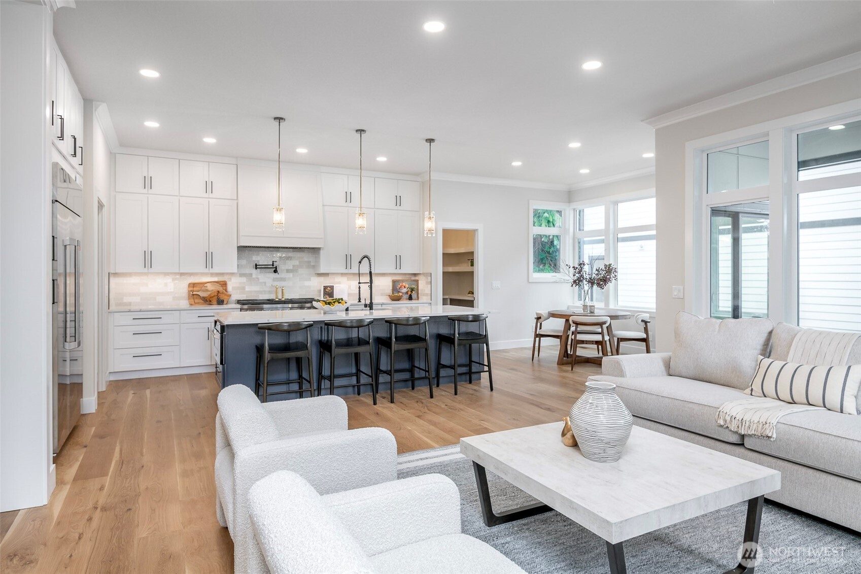 Chef's kitchen with sleek quartz countertops, custom cabinetry, premium stainless steel appliances, and a spacious island designed for both everyday living and entertaining.