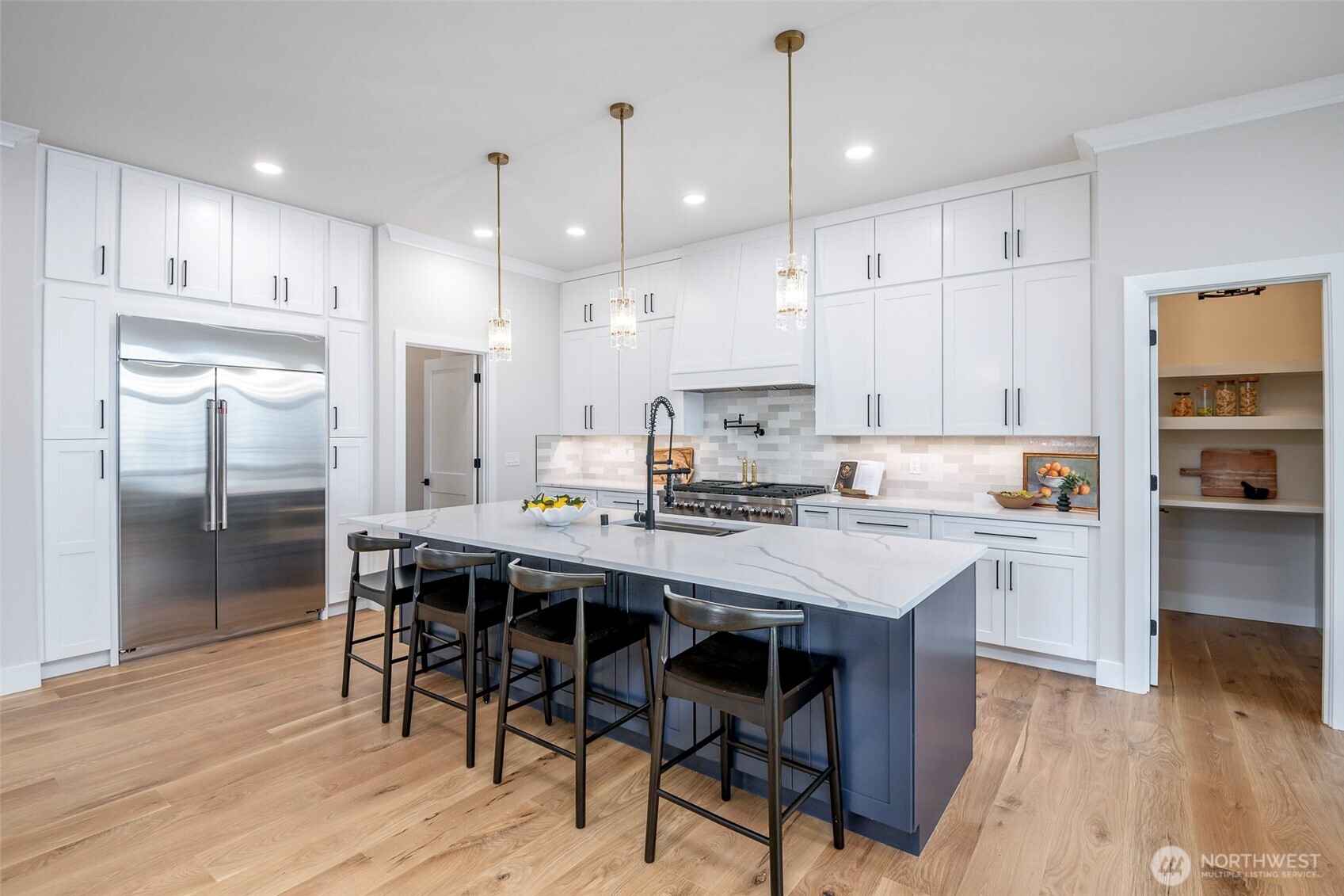 Light filled dining nook with expansive windows and sliding glass doors that open to the back patio.