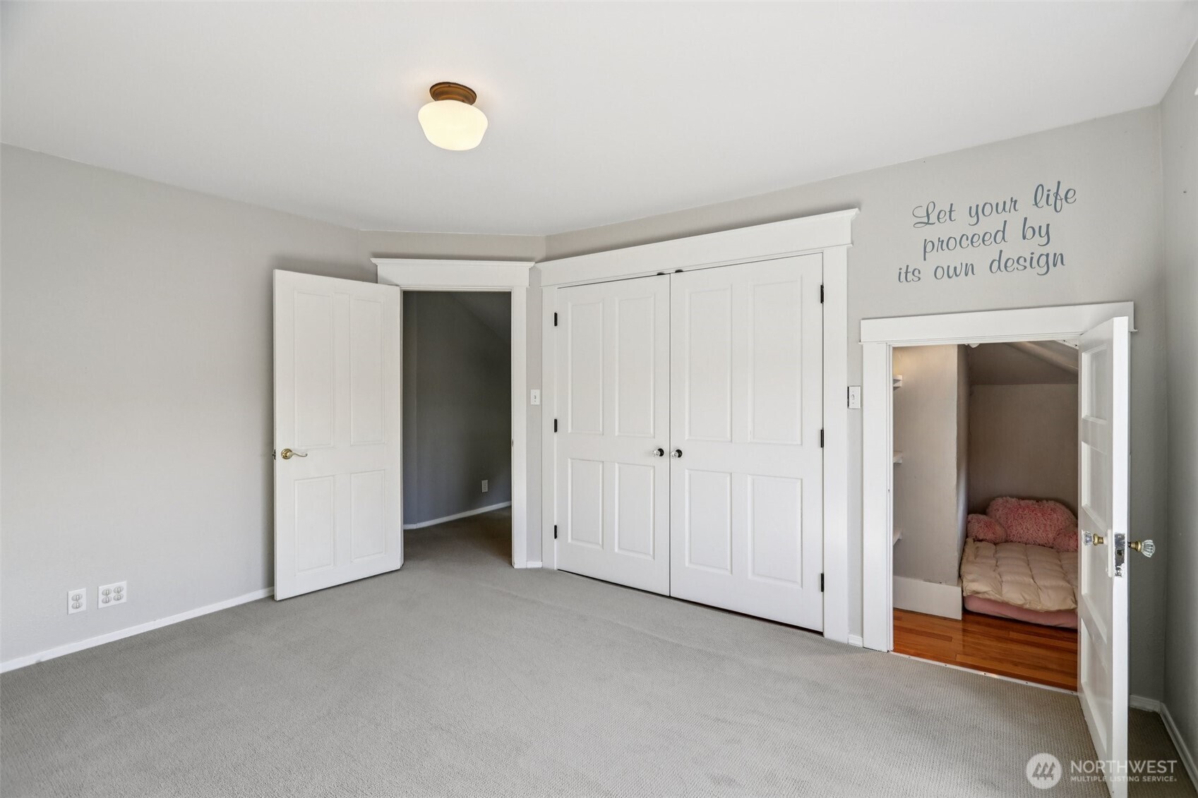 West facing bed showing closed closet doors and hide-away nook