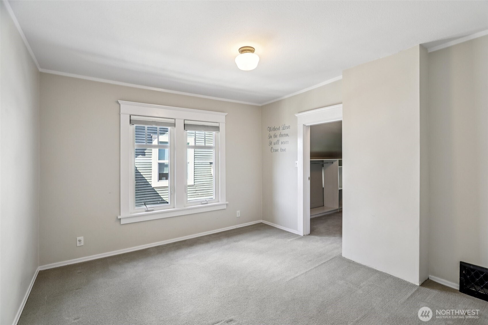 north facing bedroom with large walk-in closet which is plumbed for washer/dryer