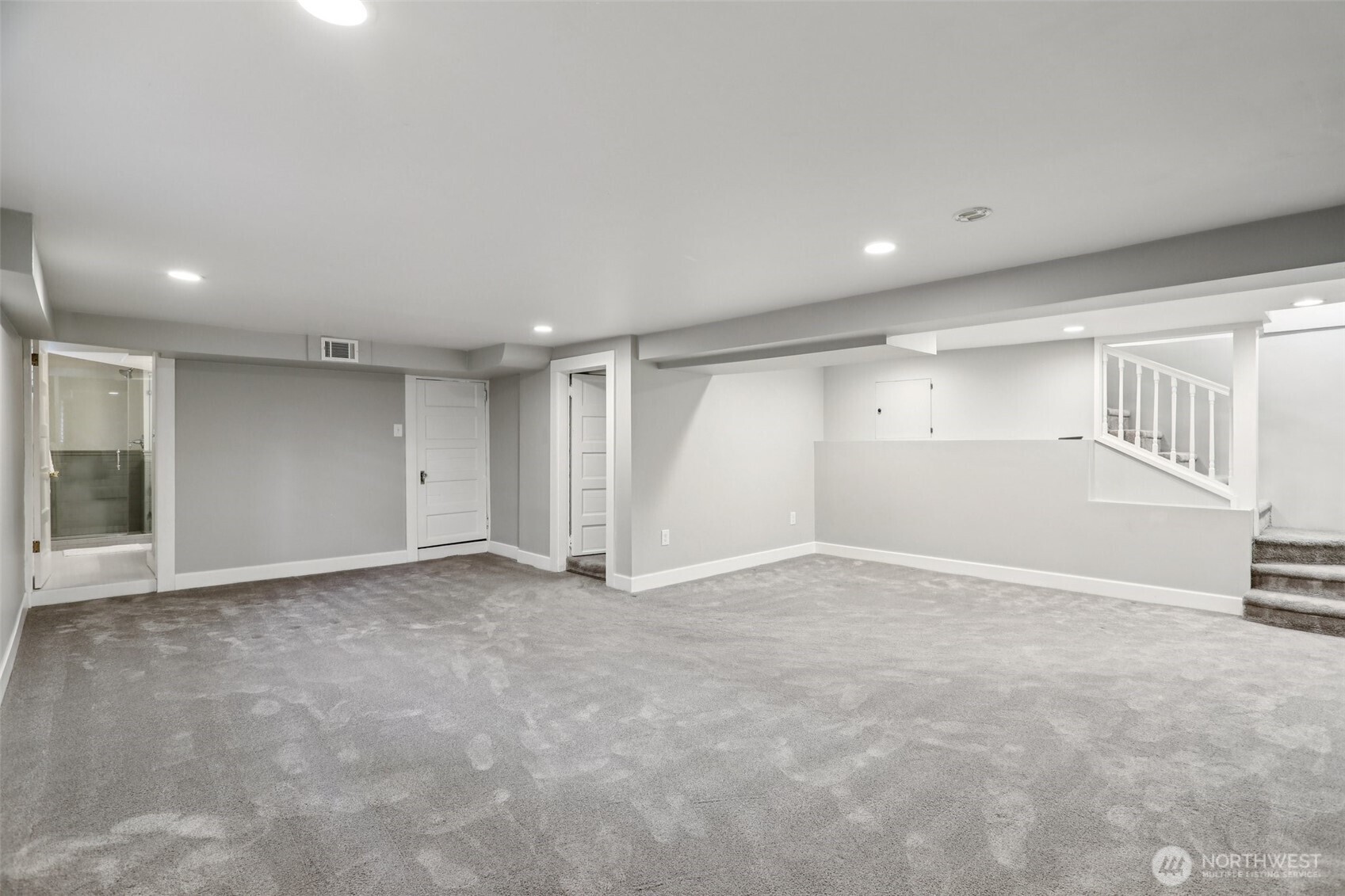 spacious recreation area in basement - garage, three-quarter bathroom, guest room, and laundry all accessed from this room