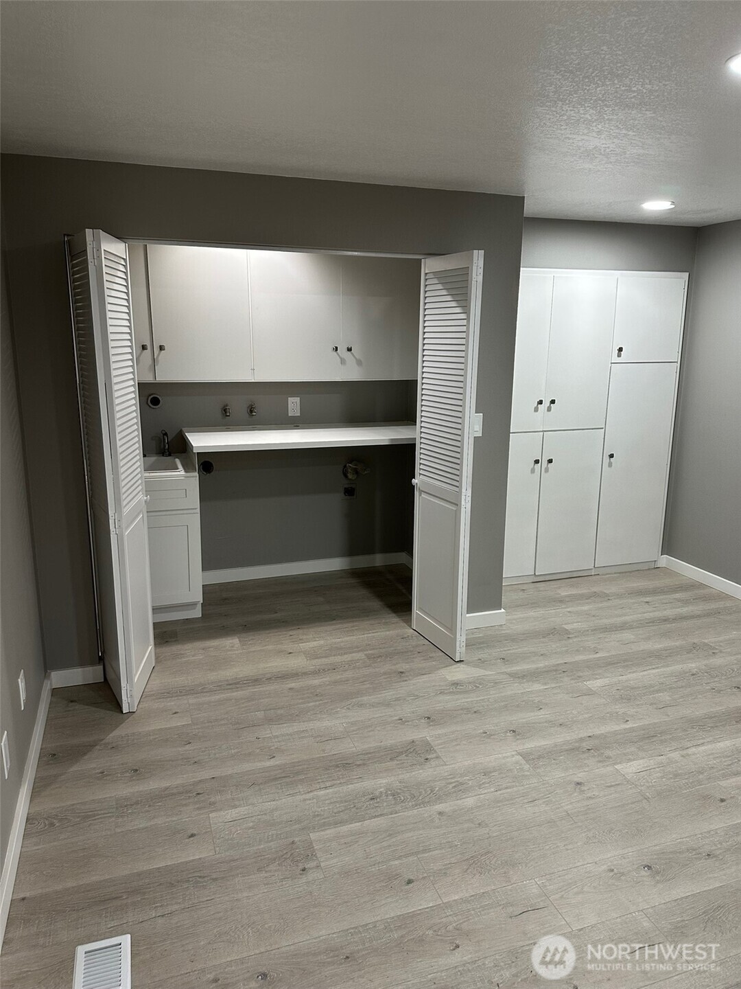 Laundry area with utility sink and more built in cabinets
