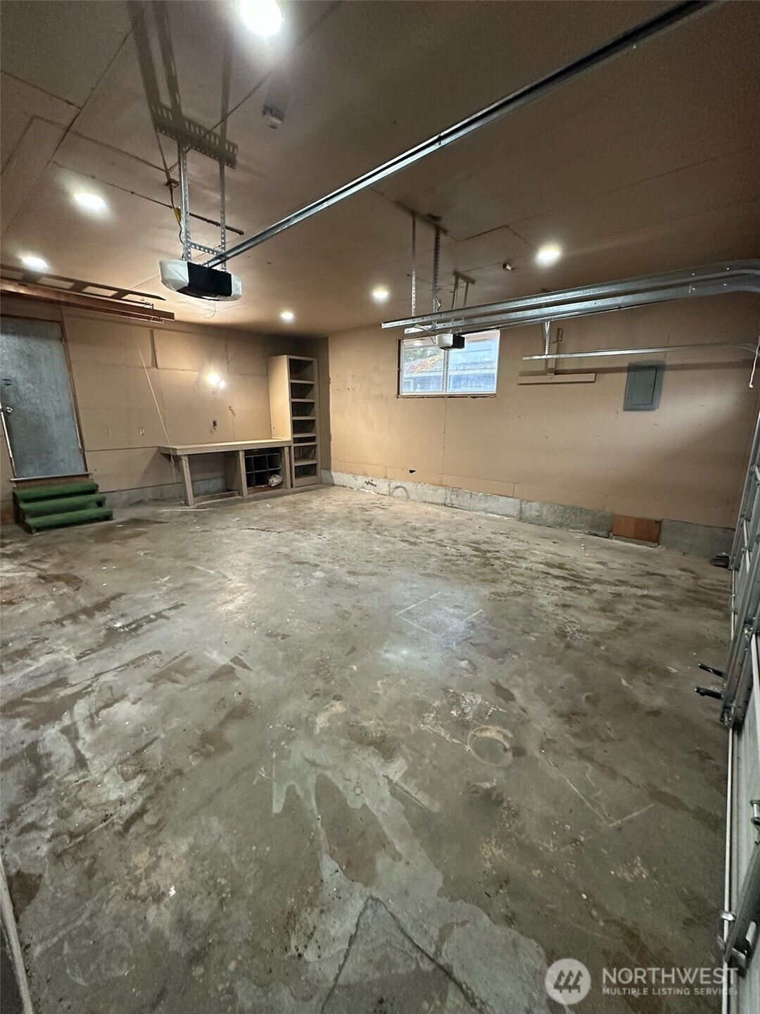 Large garage door...with pull down ladder and plenty of storage