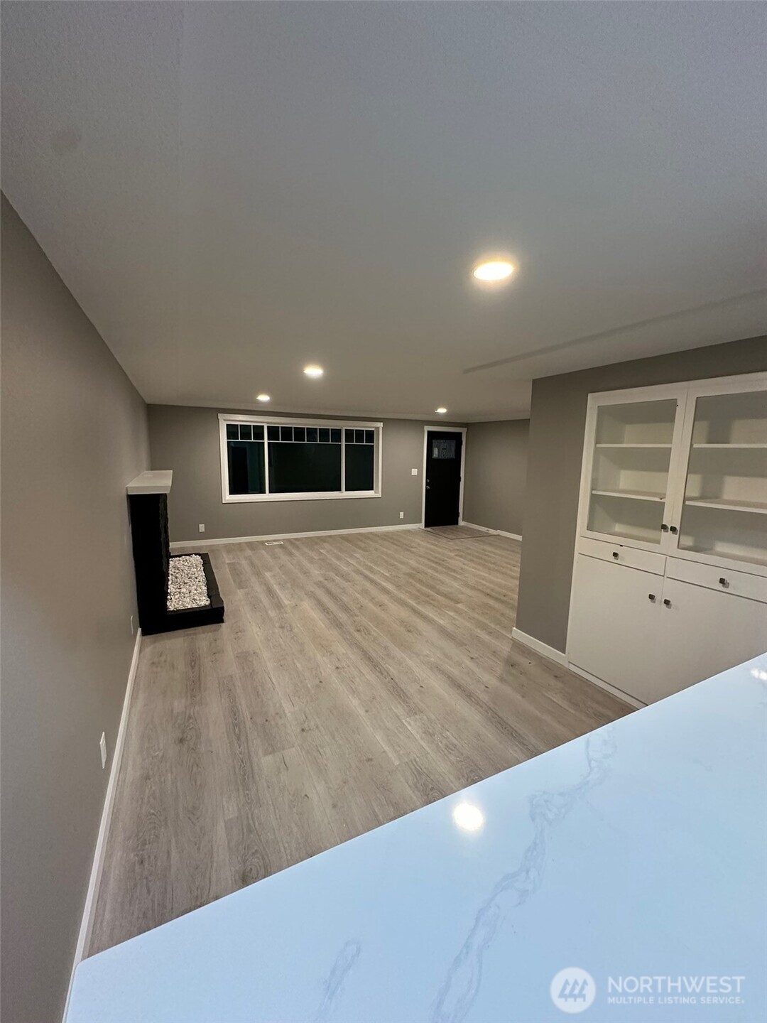 Looking from the kitchen towards front window and front door... there is also built in cabinets