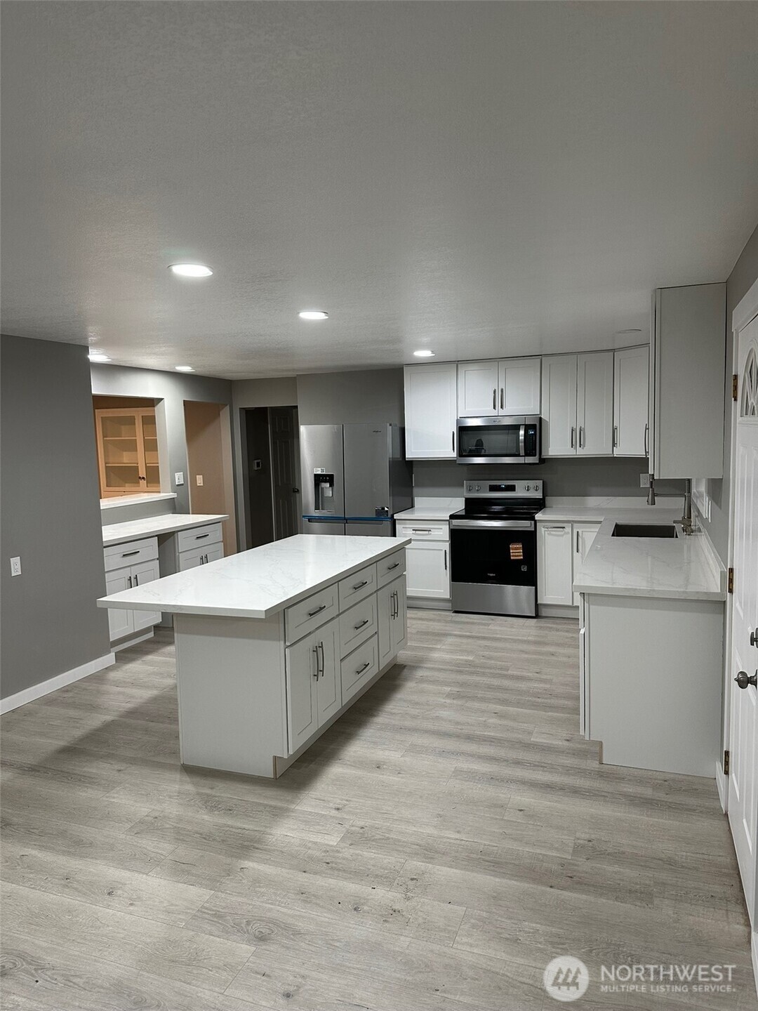 To the left of the kitchen is a pass through bar and nook