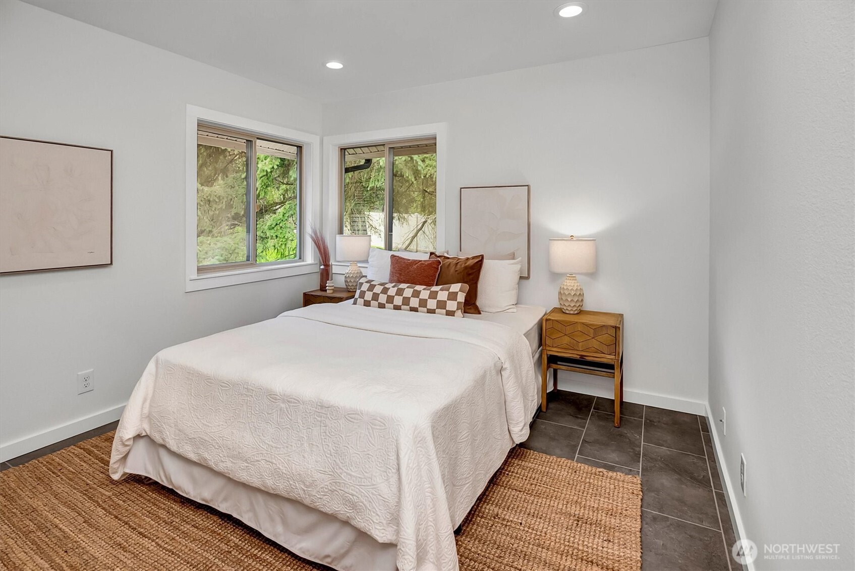 The 2nd/guest bedroom w/beautiful windows, new flooring, lighting, paint and is nicely sized for a queen size bed.