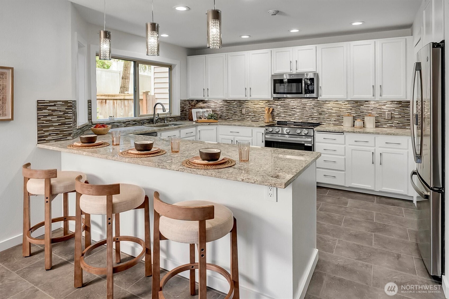 Warm, inviting...NEW(er) SS appliance, custom tile touches, new lighting.....new, fresh and clean interior paint! This kitchen has a walk in pantry, ideal island w/counter seating + lots of storage too! Large, open, bright and beautiful in every way is this home in the desirable community of Walnut Hills in Redmond.