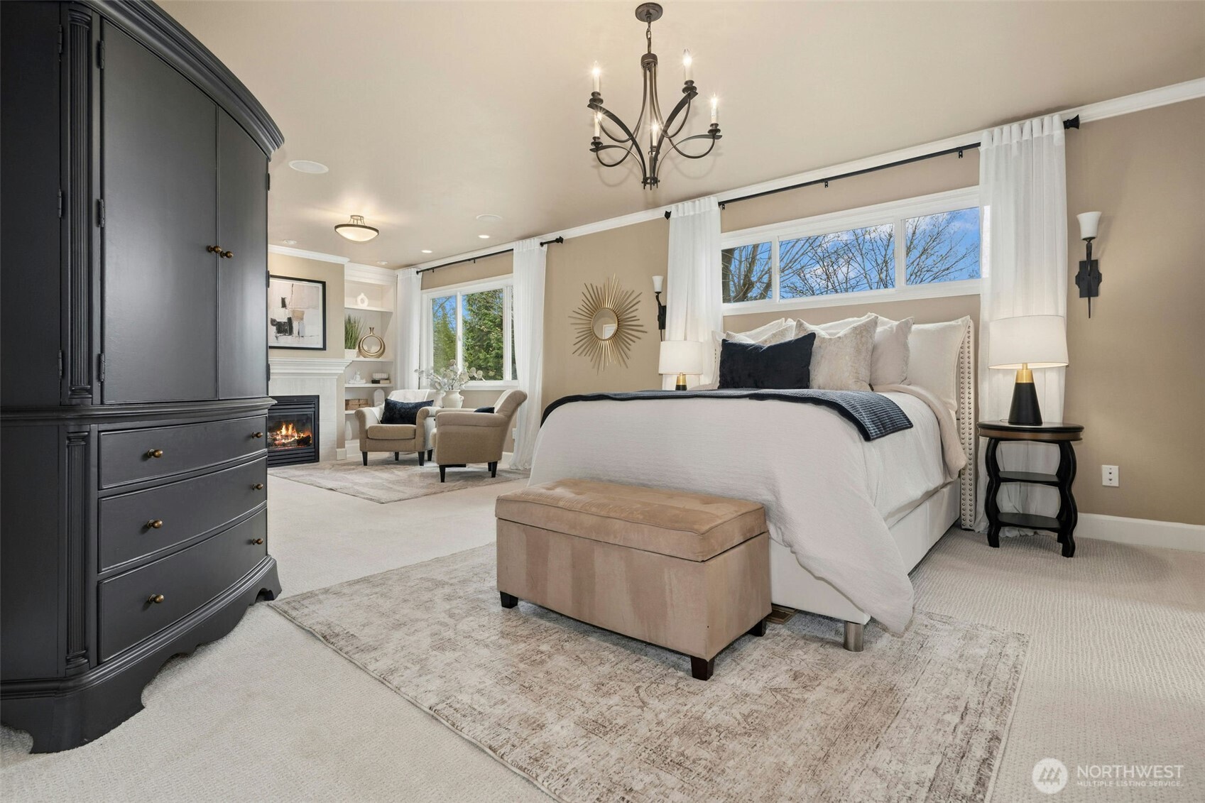 Gracious primary with cozy sitting area and fireplace.