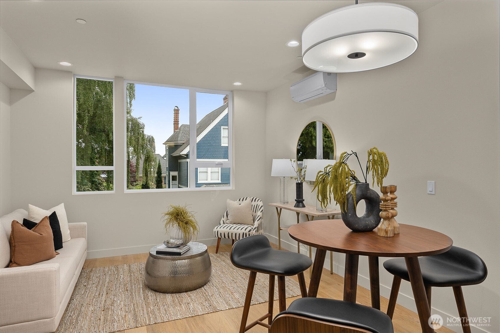 The dining space is wrapped in windows and highlighted by sleek lighting, offering a sunny setting for every meal.