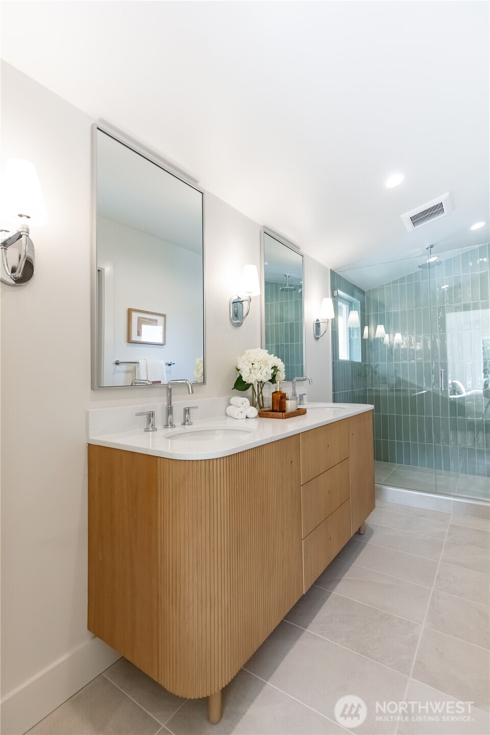 Primary spa-inspired bathroom with custom tile work and frameless glass shower