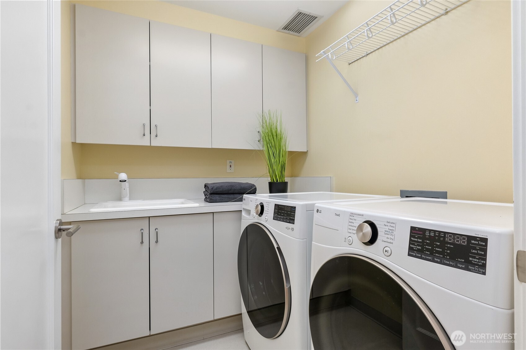 Laundry room with plenty of extra storage.