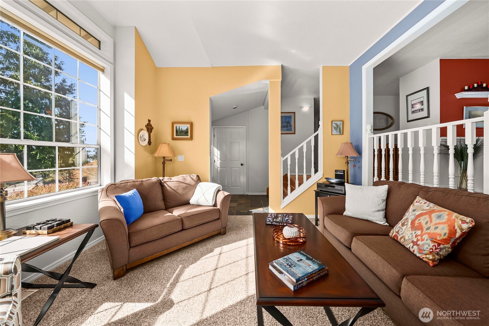Warm and inviting living room off the entryway with gas fireplace