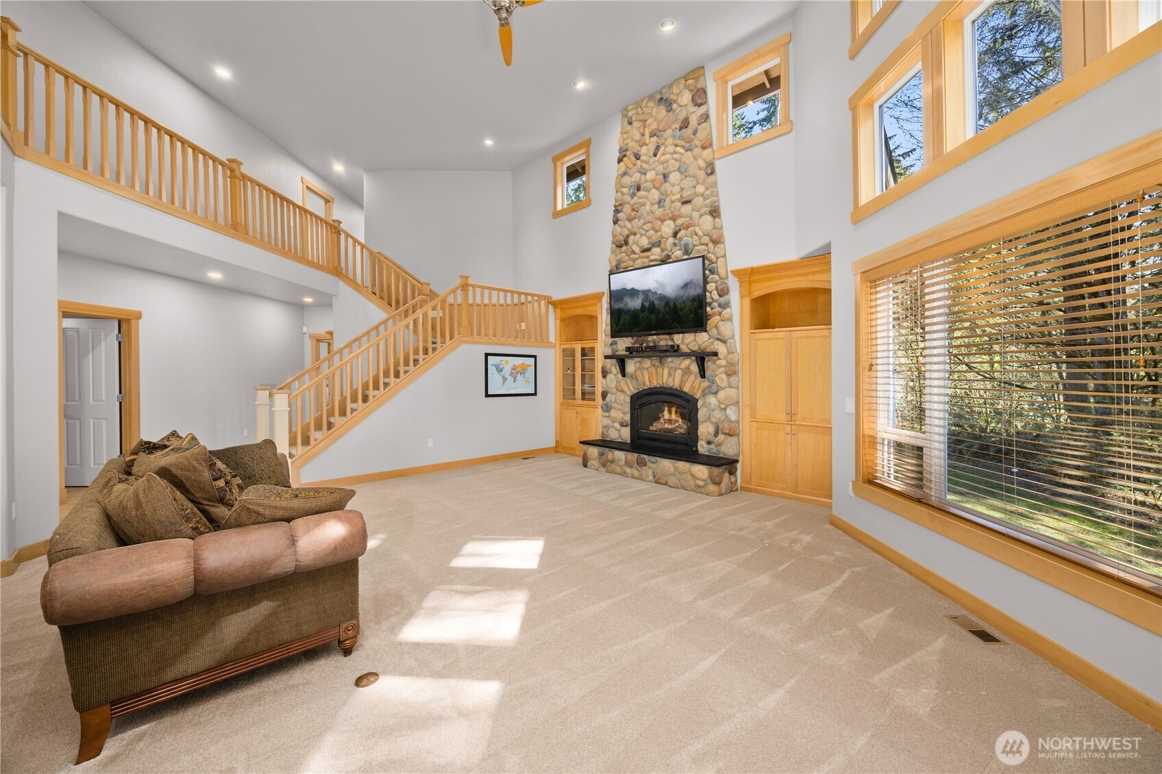Great room with magnificent stone gas fireplace and has surround sound throughout all levels of the home.