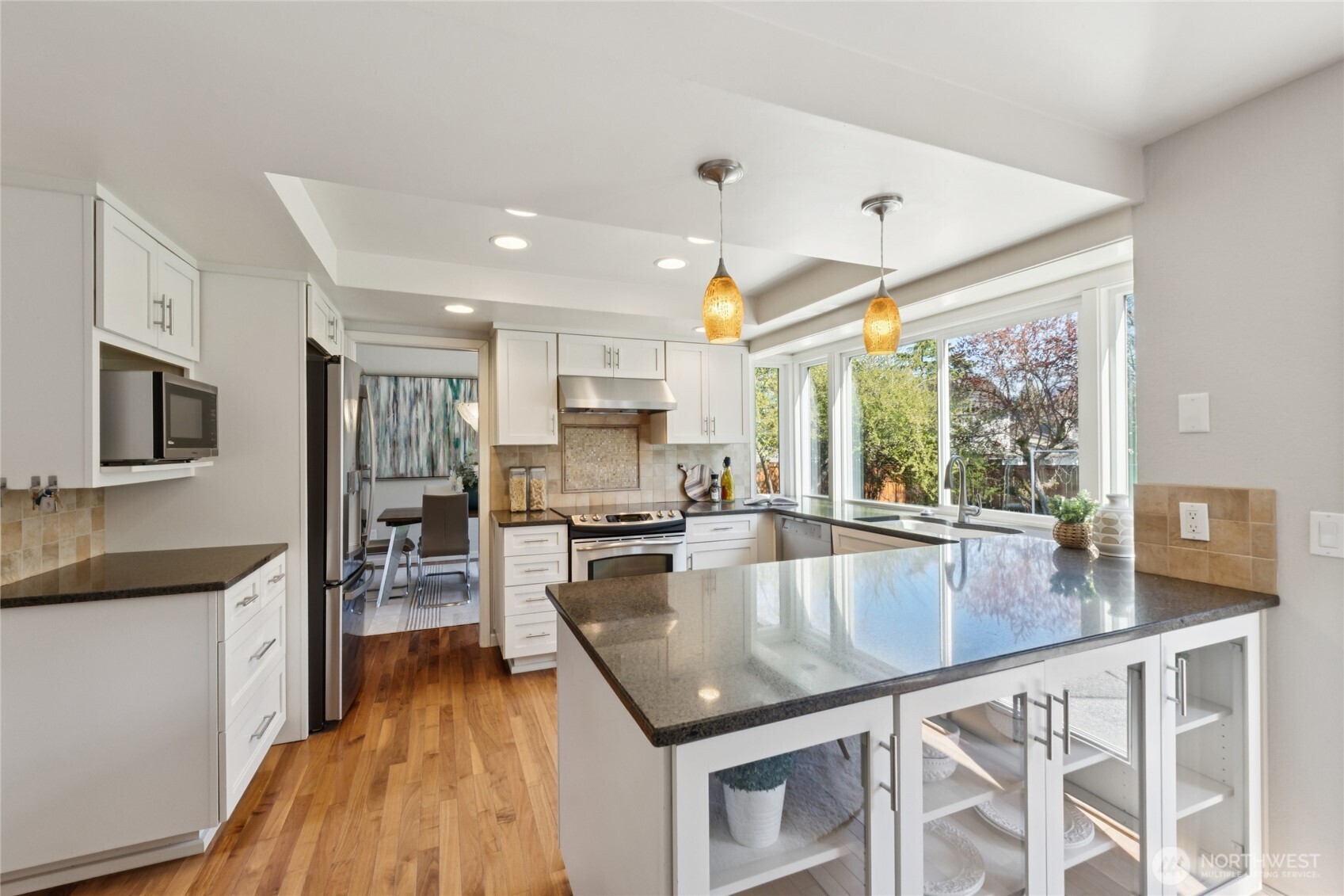 The kitchen opens has a generous counter space, abundant cabinetry, stainless steel appliances and natural light that just keeps on keeping on and pouring in—this kitchen was designed for both function and ease.