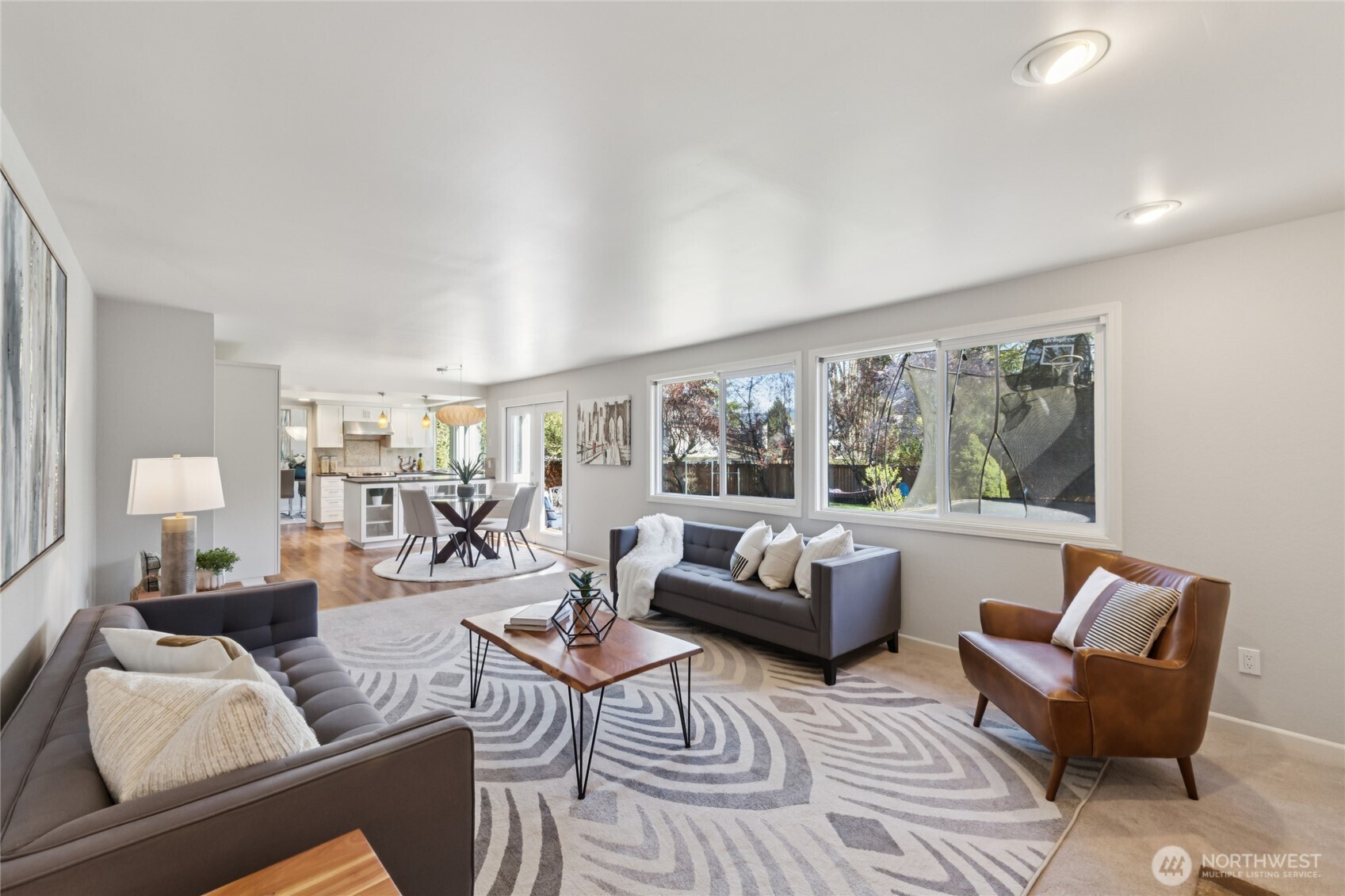 Another view of the great room shows its connection to the kitchen and outdoors—it flows, it is connected, and look at all the light flooding in!